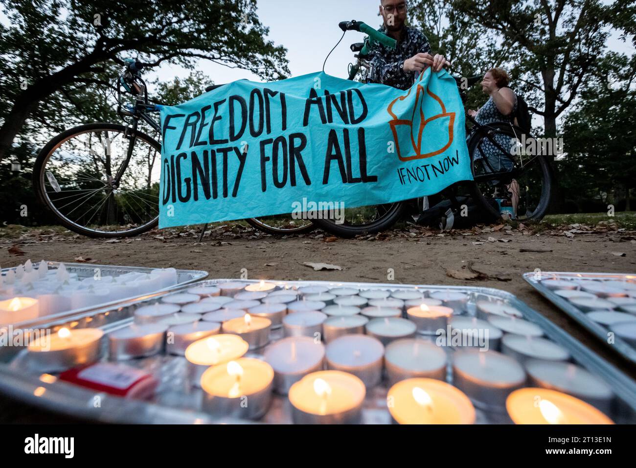 Washington, United States. 10th Oct, 2023. A volunteer arranges a banner during a candlelight vigil hosted by If Not Now to honor Israeli and Palestinian victims of decades of violence in the Middle East. (Photo by Allison Bailey/NurPhoto) Credit: NurPhoto SRL/Alamy Live News Stock Photo