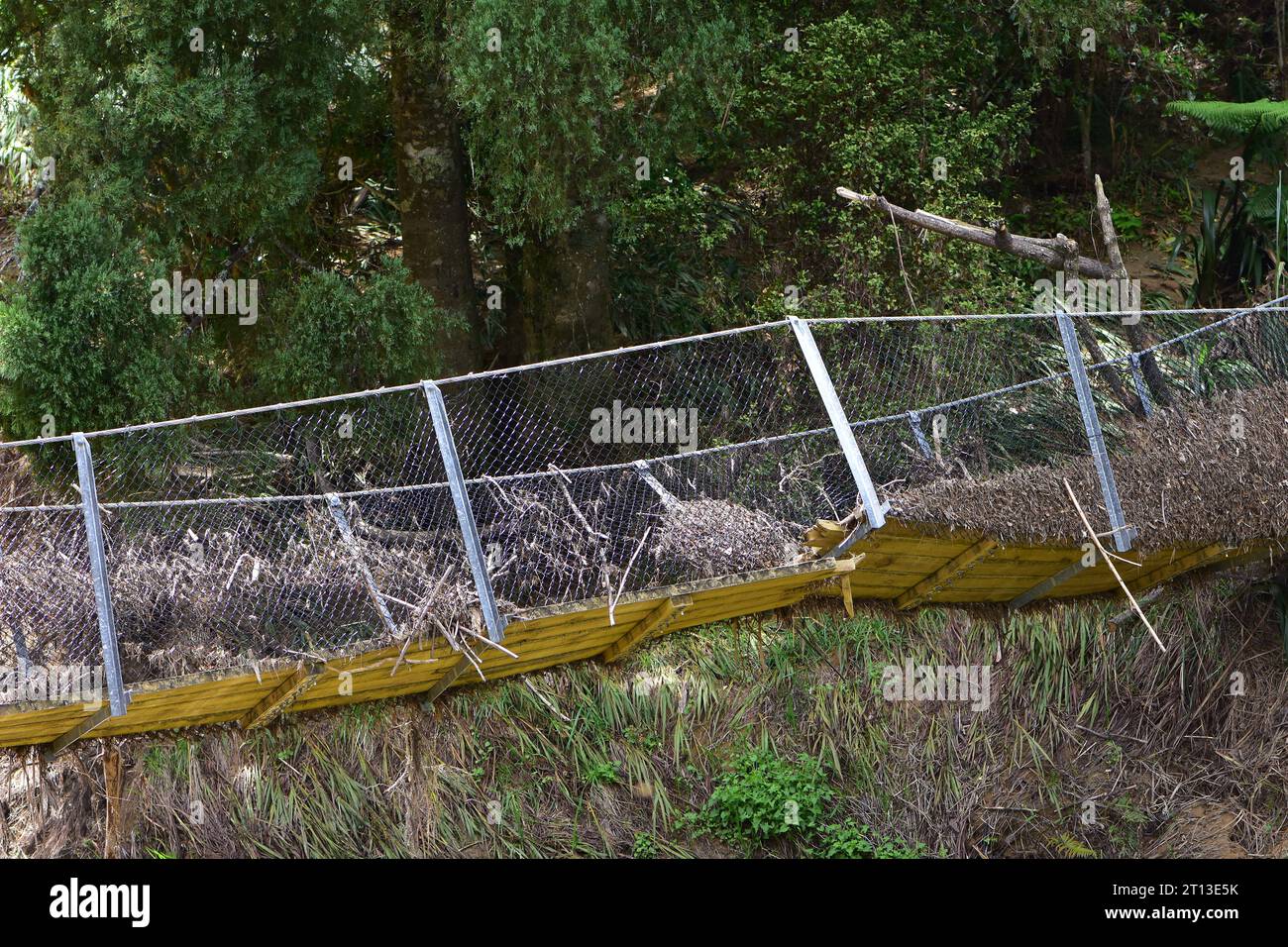 Suspension pedestrian bridge after flood with broken floor planking and