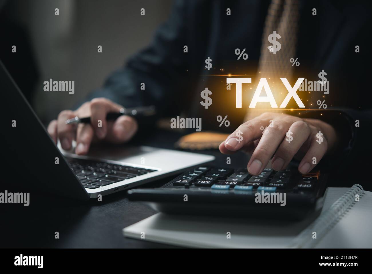 Businessman using calculation and laptop income tax online return form for payment. Financial research, government taxes icon virtual screen. Stock Photo
