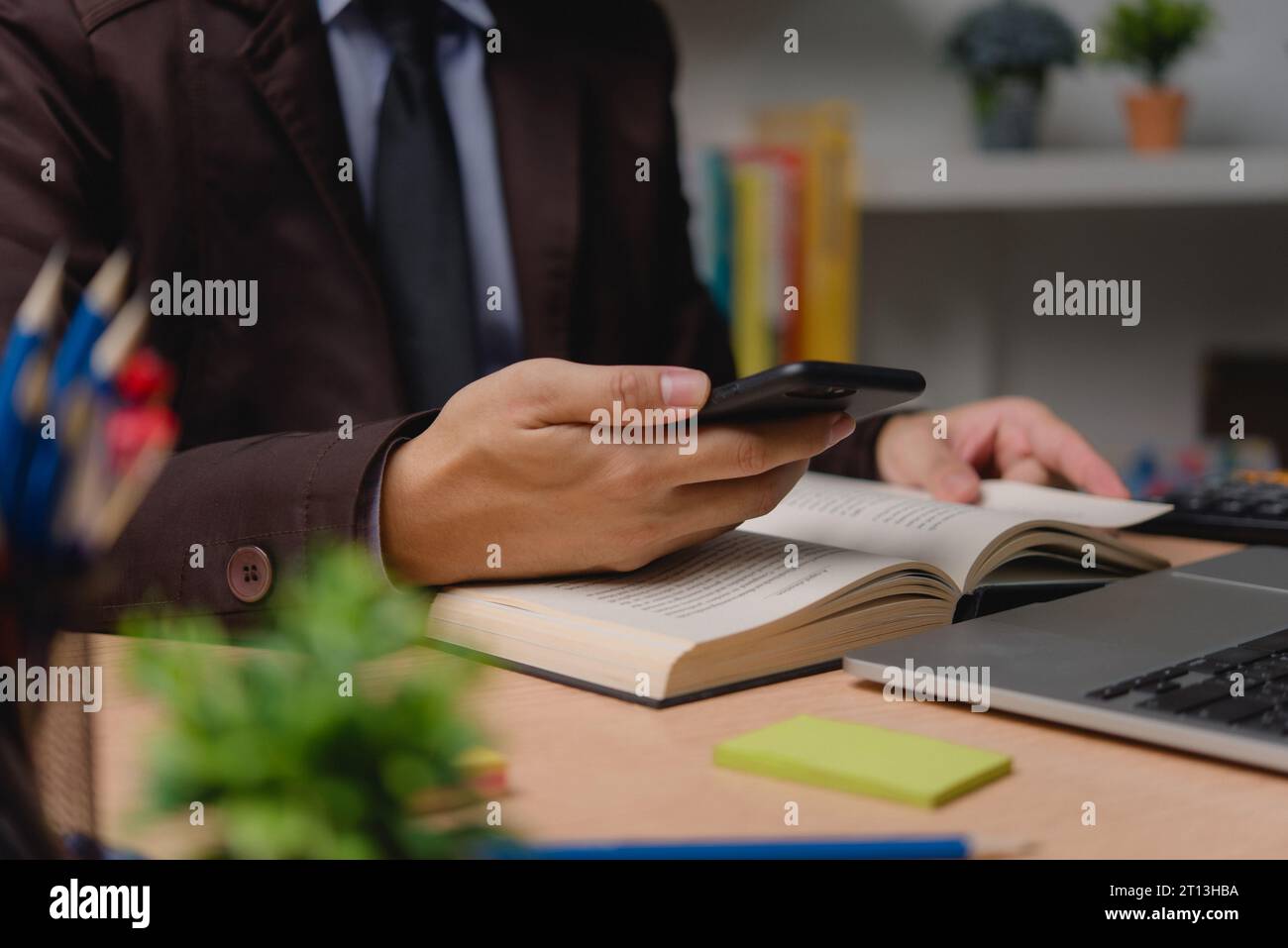 Man using smartphone digital devices reading a book workstation digital