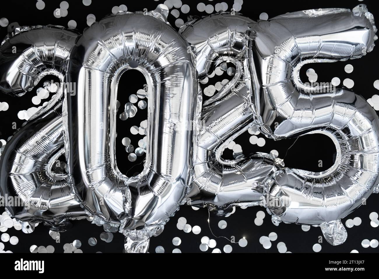Happy new year 2025 metallic balloons with confetti on dark black