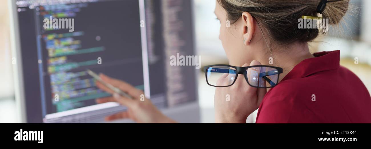Female programmer checks code looking at screen of computer Stock Photo ...