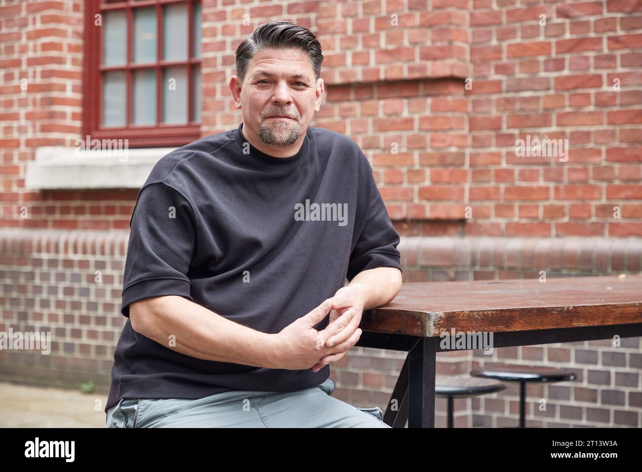 Hamburg, Germany. 18th Sep, 2023. Tim Mälzer, chef and author, sits outside the restaurant 'Bullerei' on the occasion of an interview about his new book and the situation of pubs in Hamburg. Credit: Georg Wendt/dpa/Alamy Live News Stock Photo