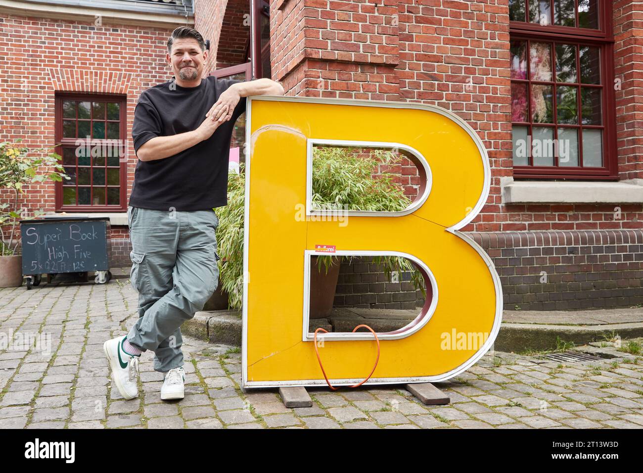 Hamburg, Germany. 18th Sep, 2023. Tim Mälzer, chef and author, stands in front of the restaurant 'Bullerei' on the occasion of an interview about his new book and the situation of pubs in Hamburg. Credit: Georg Wendt/dpa/Alamy Live News Stock Photo