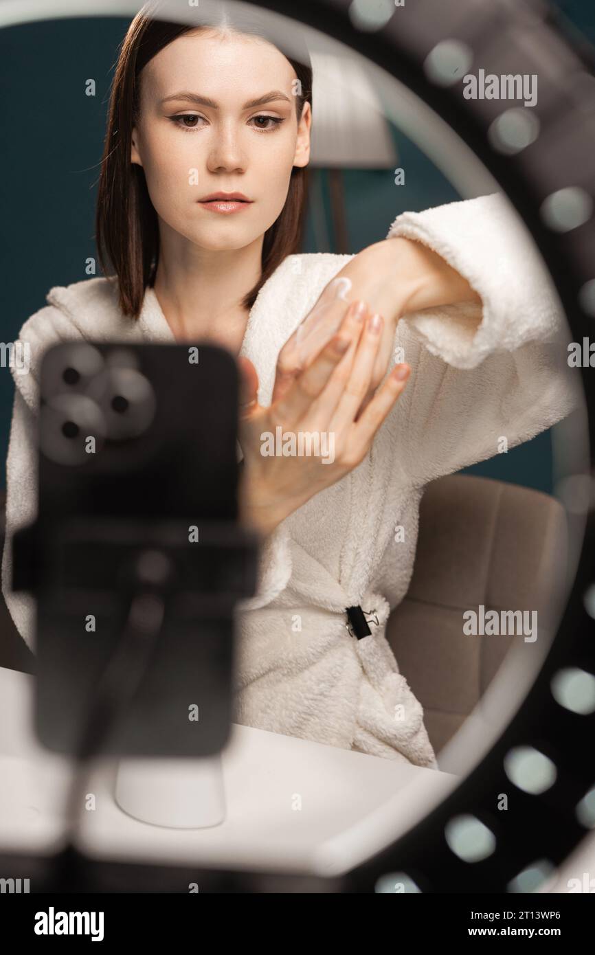 Video review. Cute and young blogger presenting beauty products while  making a new video tutorial for her vlog. Beauty tutorial. Blogging. Social  Medi Stock Photo - Alamy