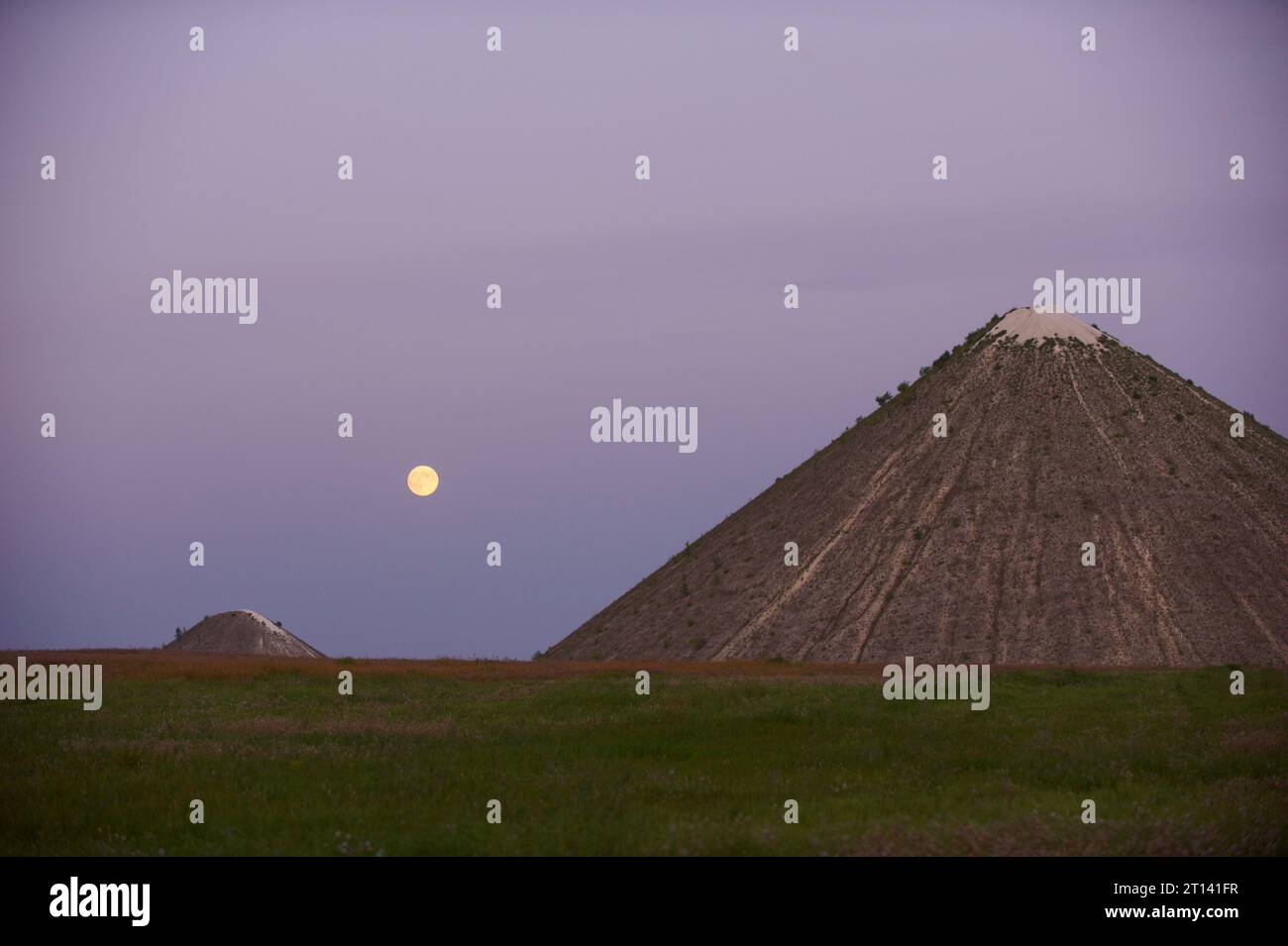 Slagheap in the field at night with full moon. Stock Photo