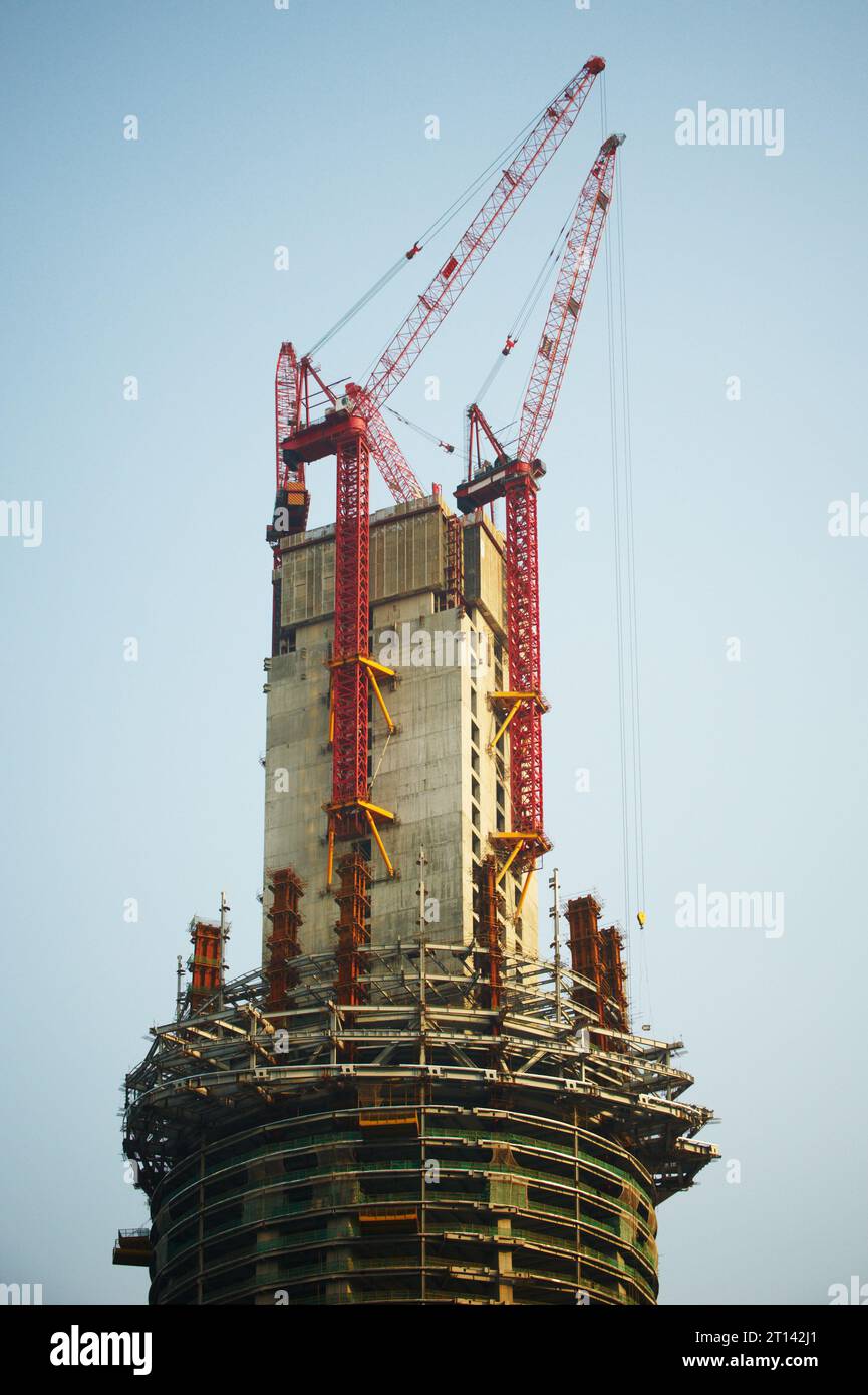construction of a skyscraper by cranes at day time, Shanghai, China ...