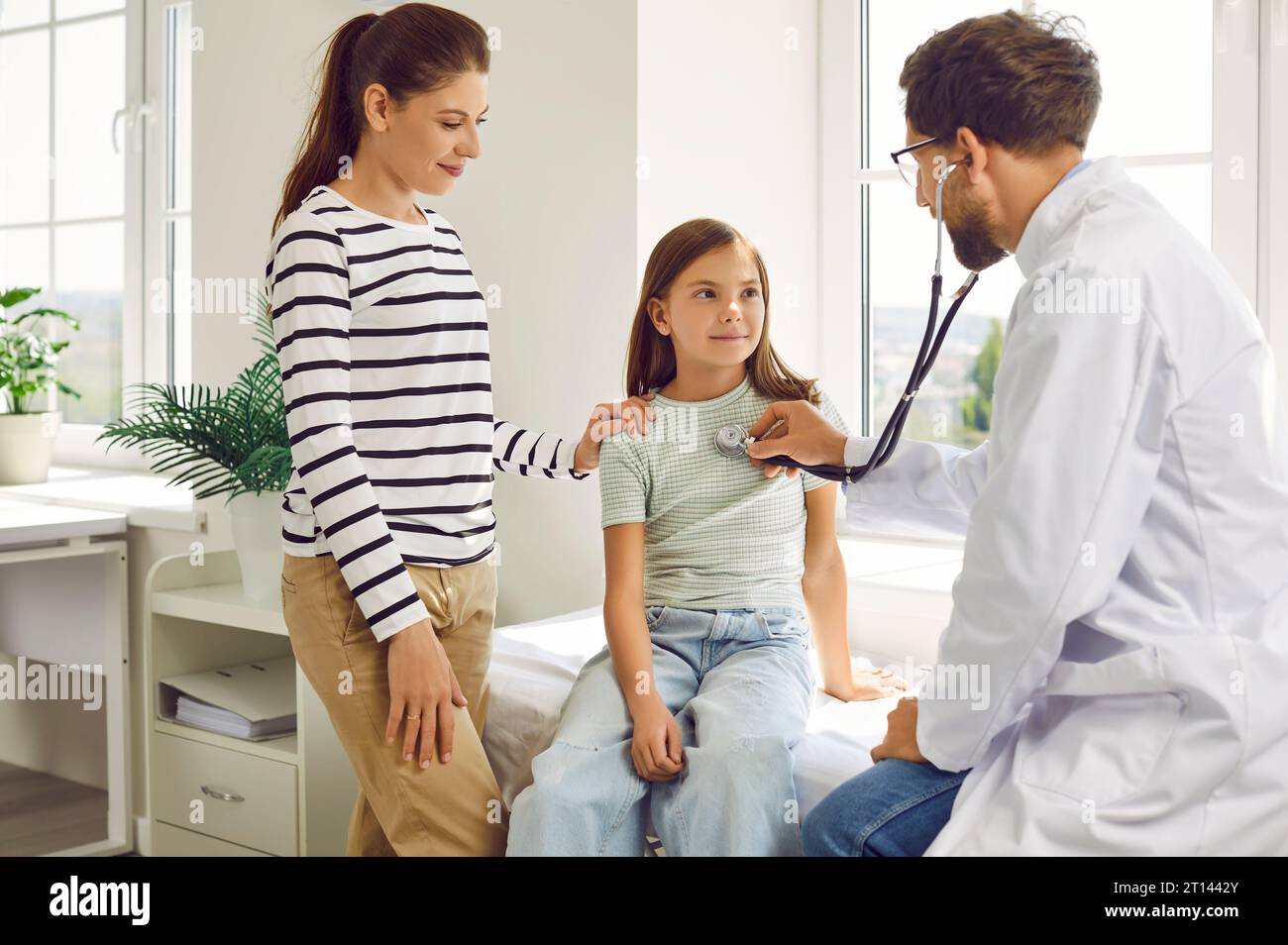Girl With Mother In Clinic For Checkup Doctor Examining Child s Lungs girl-with-mother-in-clinic-for-checkup-doctor-examining-child-s-lungs