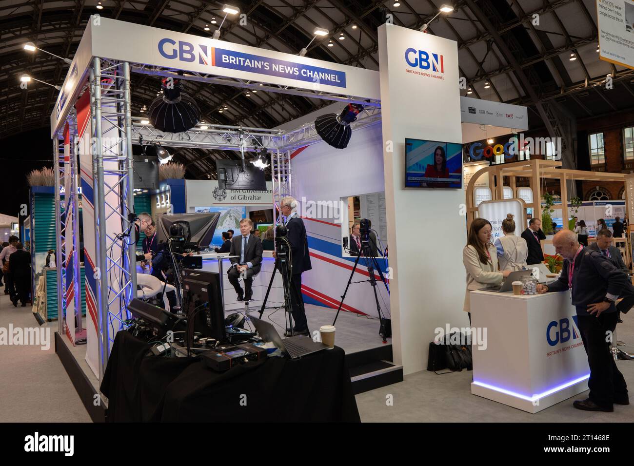 Andrew Pierce centre in  GB News stand at Manchester central during the Conservative Conference 2023. Picture garyroberts/worldwidefeatures.com Stock Photo