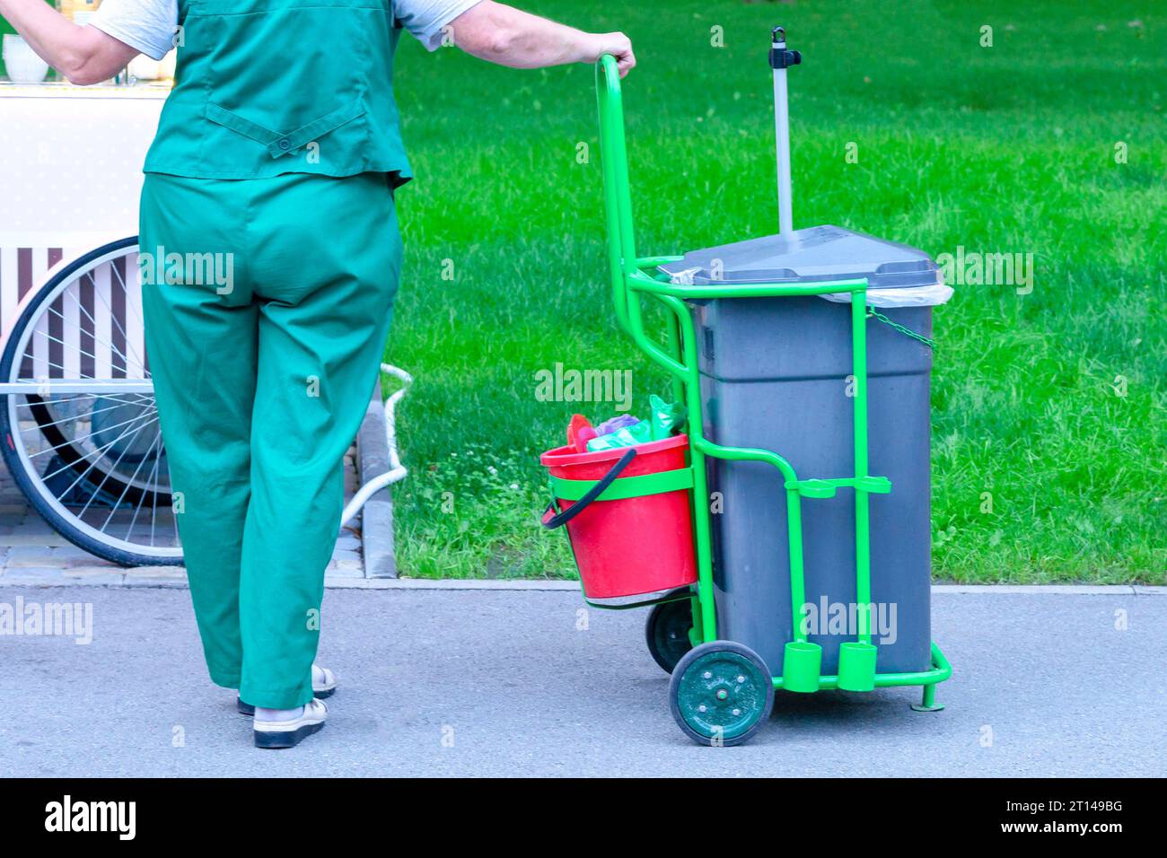 The janitor is working. The janitor with cleaning items. sanitation worker sweep street Stock Photo