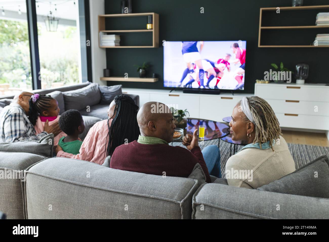 African american parents, son, daughter and grandparents watching rugby, slow motion Stock Photo
