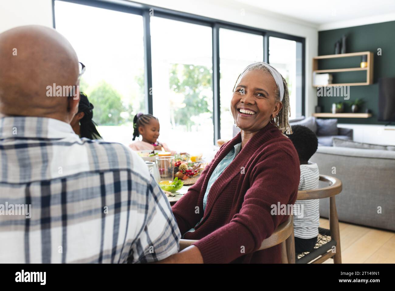 Portrait of african american grandmother with family at thanksgiving dinner table Stock Photo