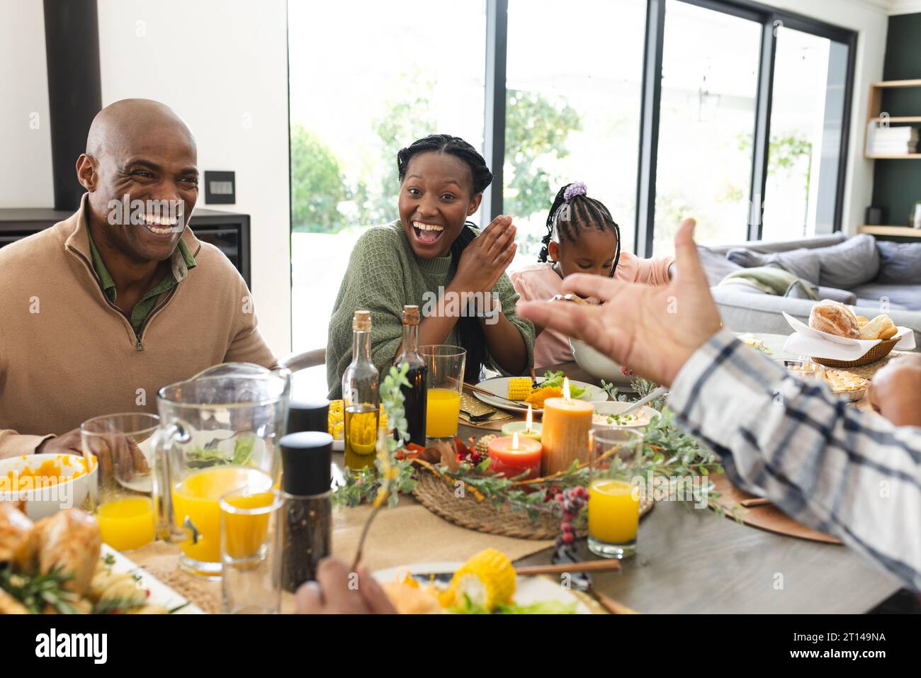 African american parents, children and grandparents celebrating at thanksgiving dinner, slow motion Stock Photo