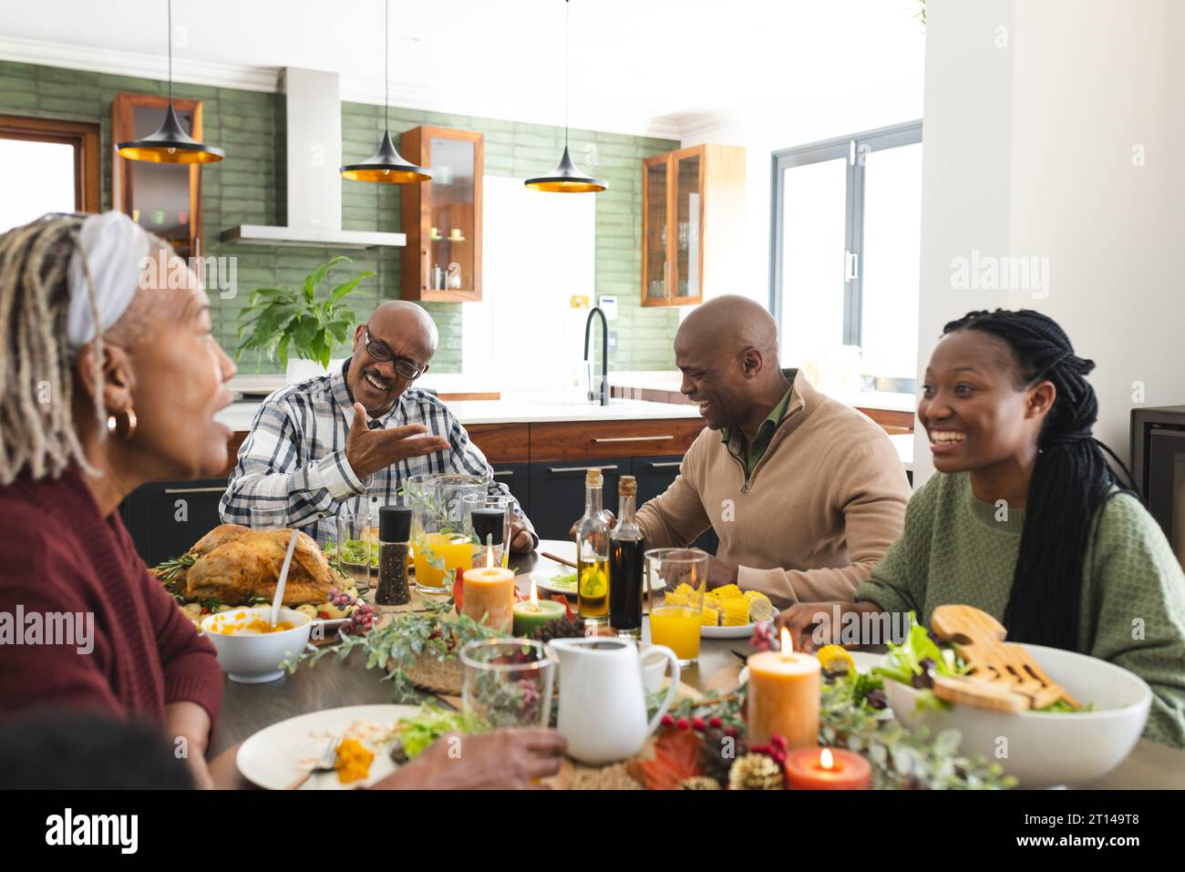 African american parents, children and grandparents celebrating at thanksgiving dinner Stock Photo