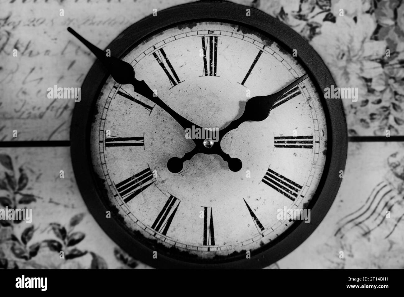 Old vintage clock on a wooden background. Round dial of the wall clock