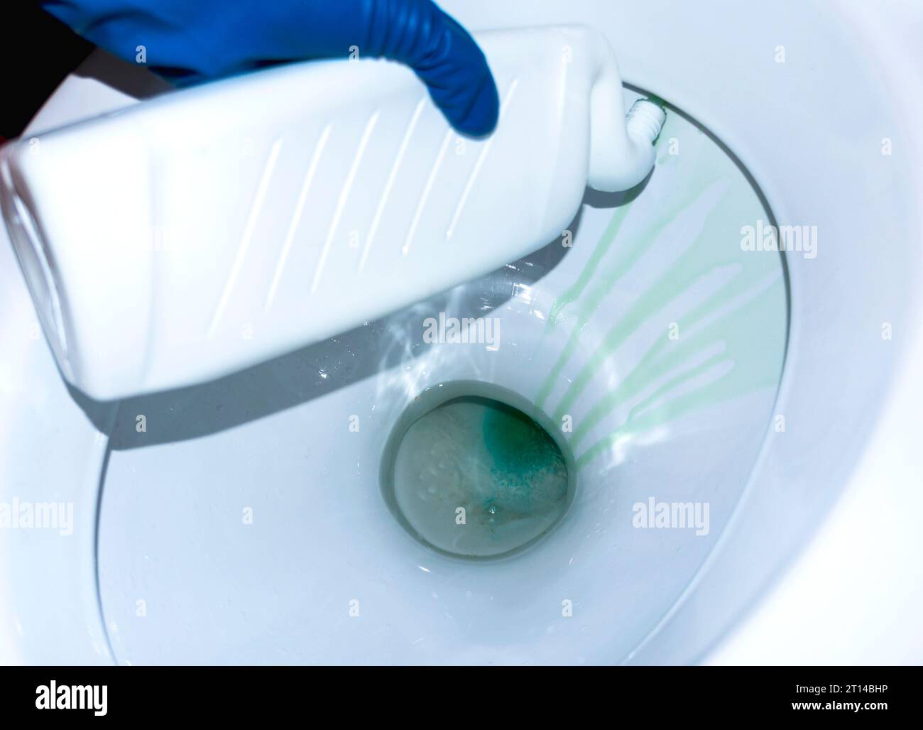 Process toilet disinfectant. Closeup. Hand holds a bottle. Purity in a
