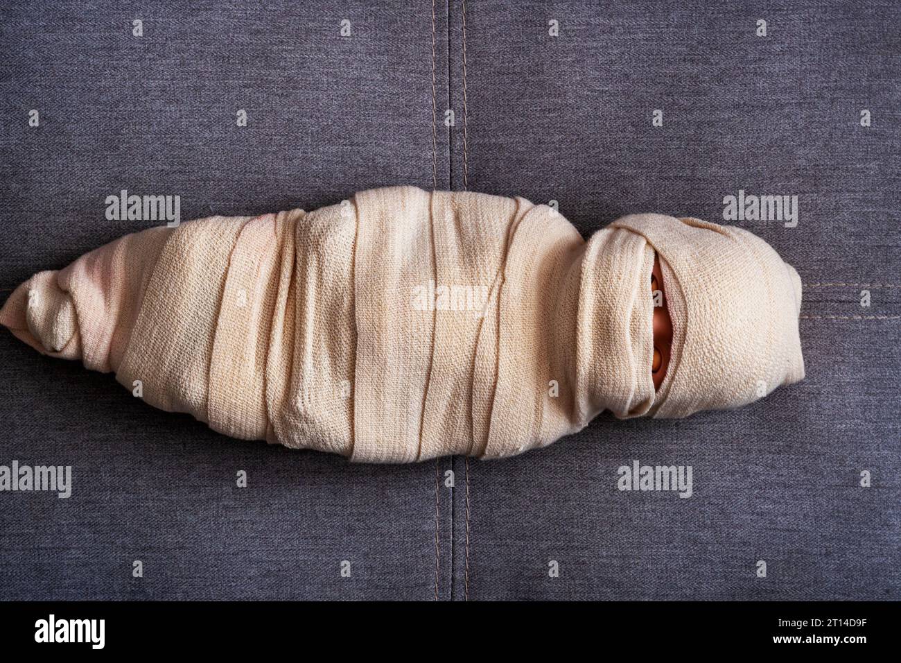 The man is wrapped in a cloth. The body is shrouded in a veil. The concept of a Muslim deceased