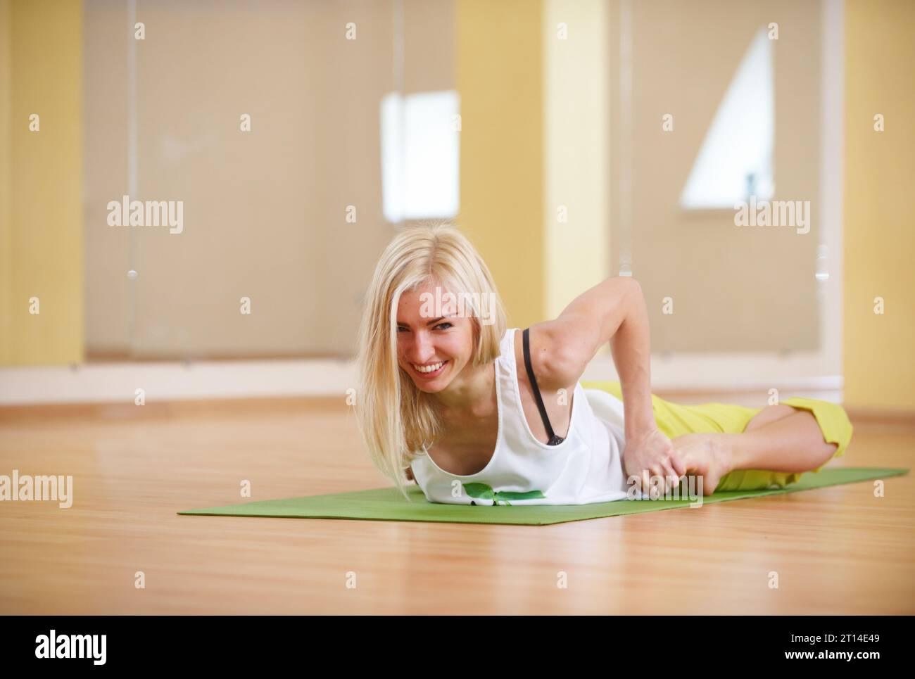 Woman in a yoga frog pose Stock Photo - Alamy