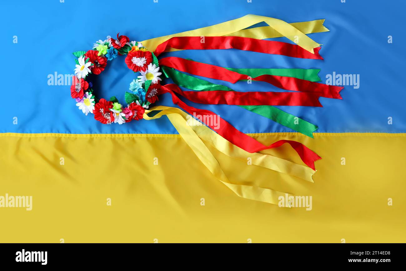 Traditional Ukrainian wreath with multi-colored ribbons on a yellow-blue flag. Flag Day, Independence, Constitution of Ukraine Stock Photo