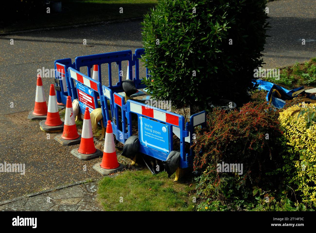 Protective barrier around area excavated by water board to replace leaking water meter Stock Photo