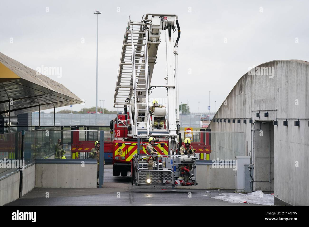 An aerial ladder platform at the scene of a fire at a multi-storey car park at Luton Airport, which has been closed with flights suspended until at least 3pm on Wednesday, after a fire ripped through the car park causing it to collapse. The fire was declared a major incident, with firefighters working through the night and into the early hours of Wednesday to extinguish the blaze. Picture date: Wednesday October 11, 2023. Stock Photo