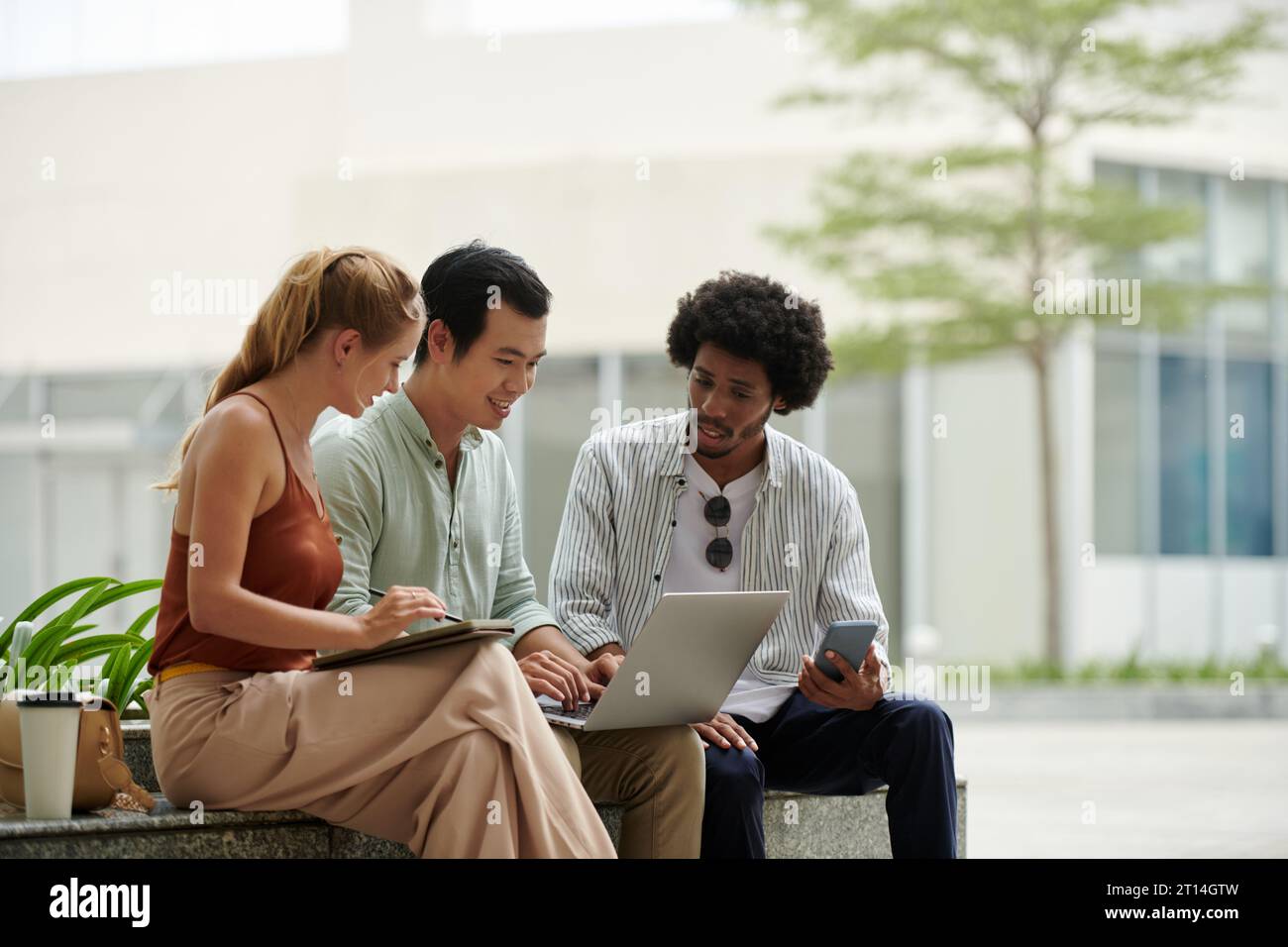 Group of positive startuppers meeting outdoors to discuss product pitch