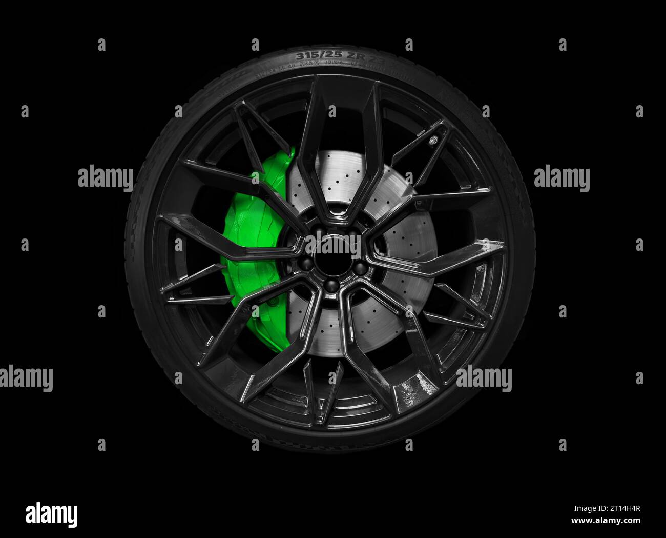 Car alloy wheel and tyre isolated on black background. New alloy wheel