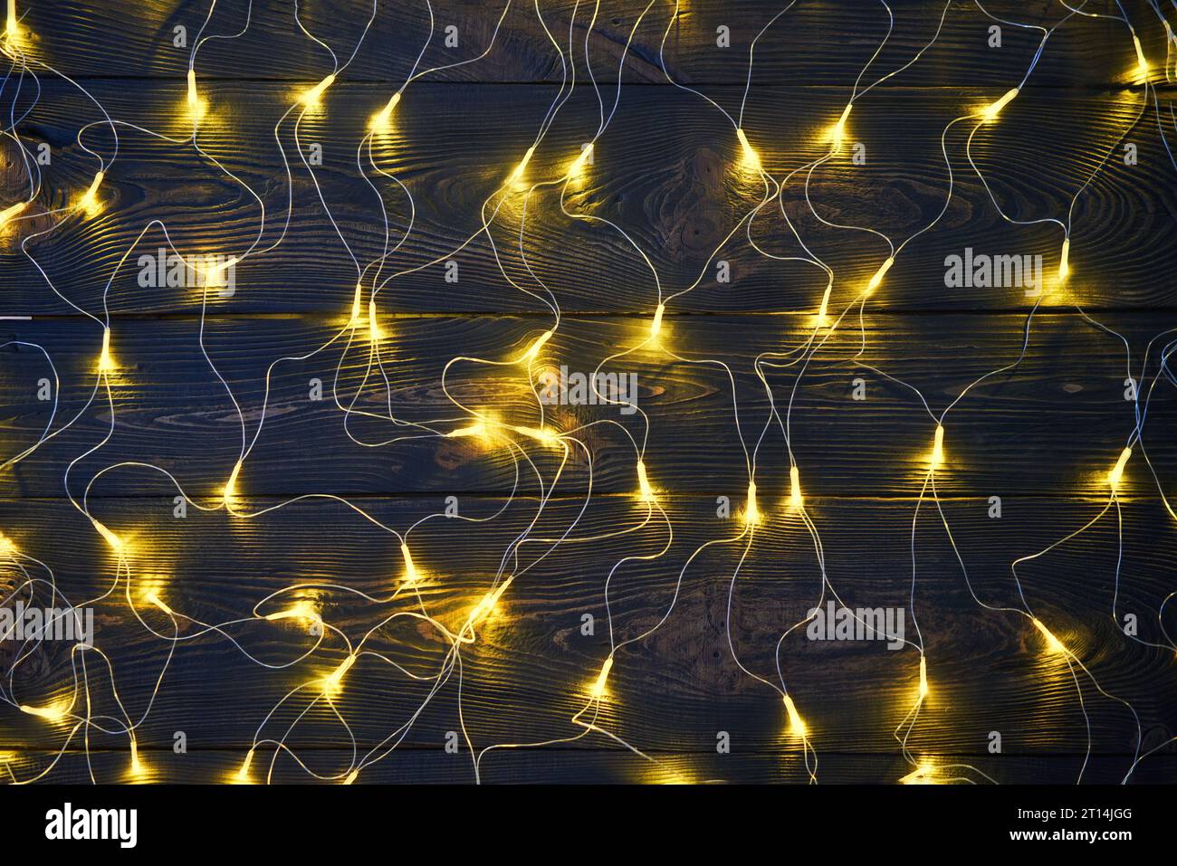 Christmas golden lights background. Merry Christmas and Happy New Year festive composition. Decorative garland Stock Photo