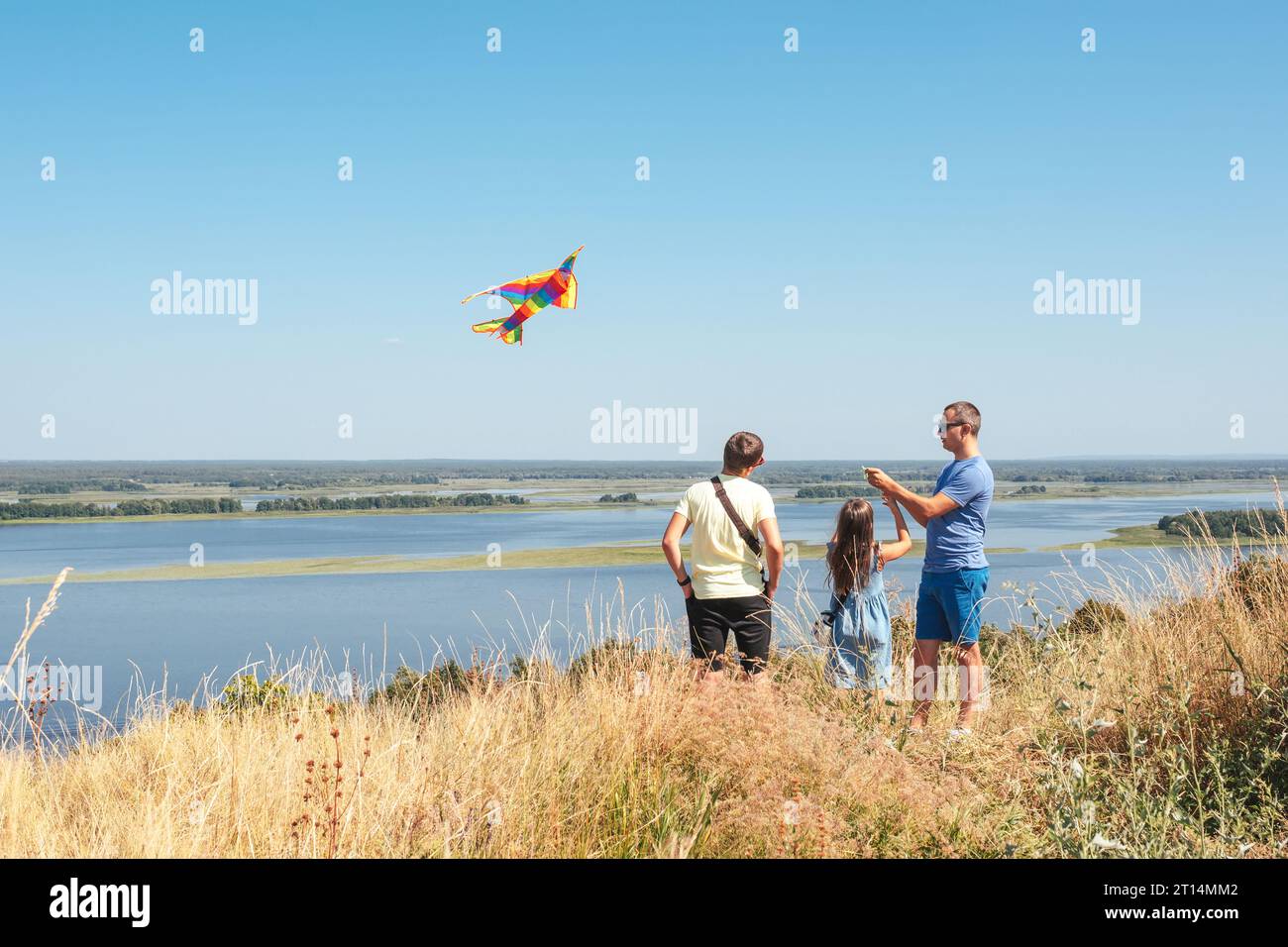 Family father, son, daughter fly a kite in nature. Stock Photo
