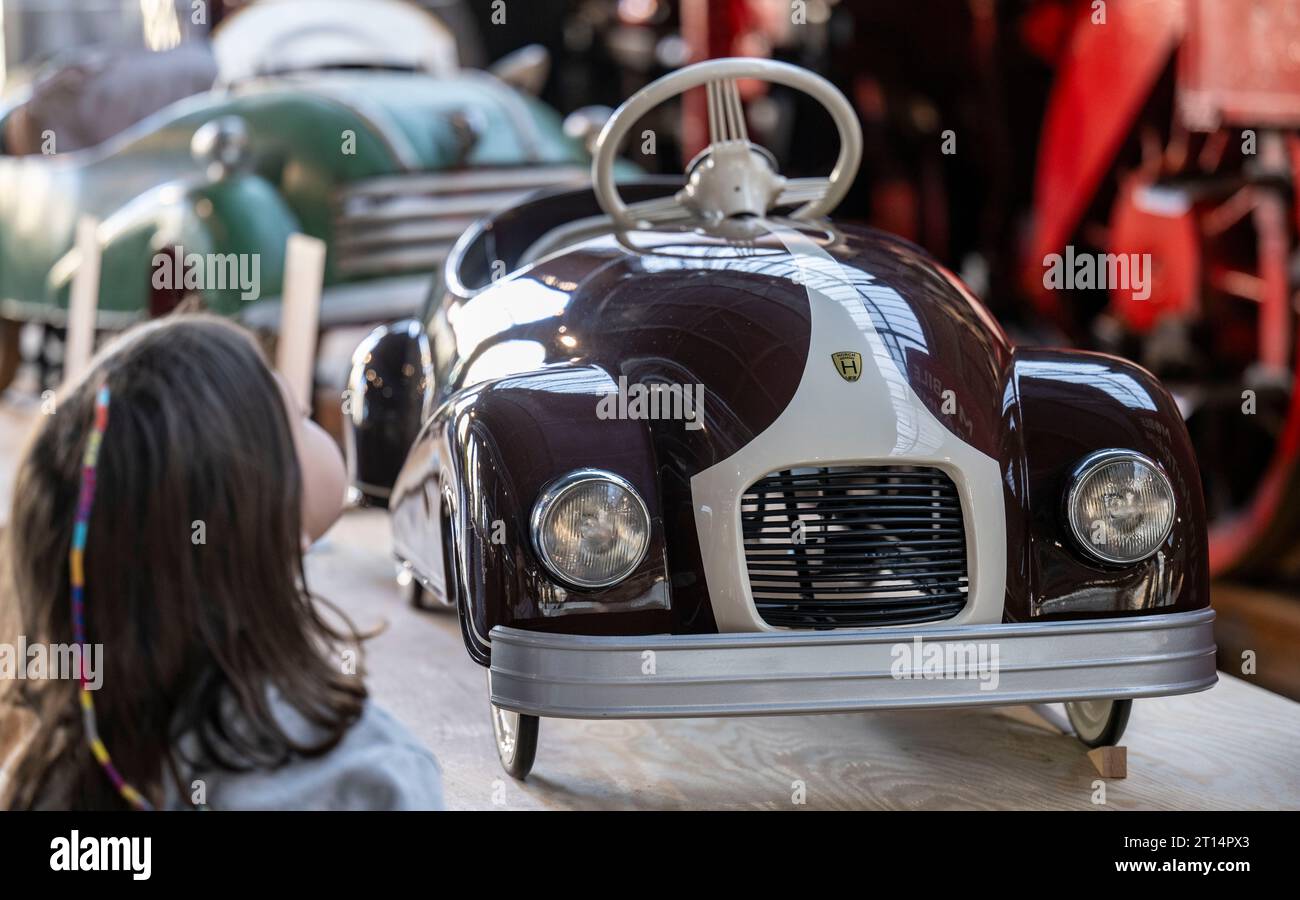 11 October 2023, Saxony, Chemnitz: A Horch F9 as a pedal car is on display in a small special exhibition on children's vehicles at the Chemnitz Industrial Museum. The model with a sheet steel body was manufactured between 1948 and 1950 at the VEB Horch Kraftfahrzeug- und Motorenwerk Zwickau. 'Mobile Kindeträume' is the title of the show, which will be on display until November 5, 2023. In cooperation with children's vehicle collector Eckart Holler and the Pohl-Ströher depot, the presentation provides insight into more than 70 years of mobile children's worlds. An unimagined range of creativity Stock Photo