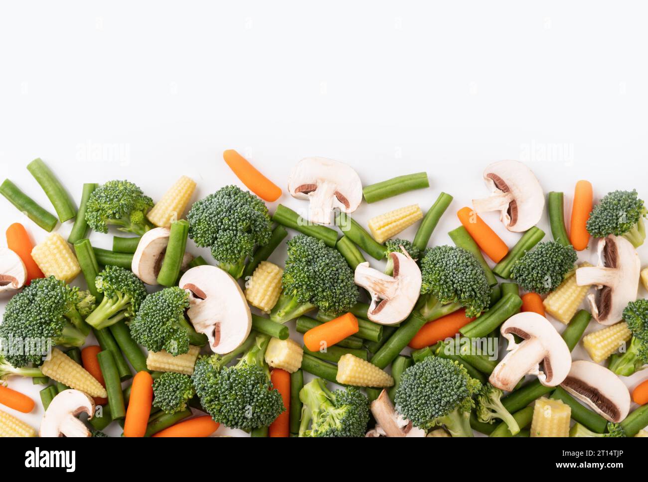 the mix raw vegetable. Flat lay of fresh raw organic vegetables on white background - broccoli, carrot, mushrooms, green beans, cauliflower, mini corn Stock Photo