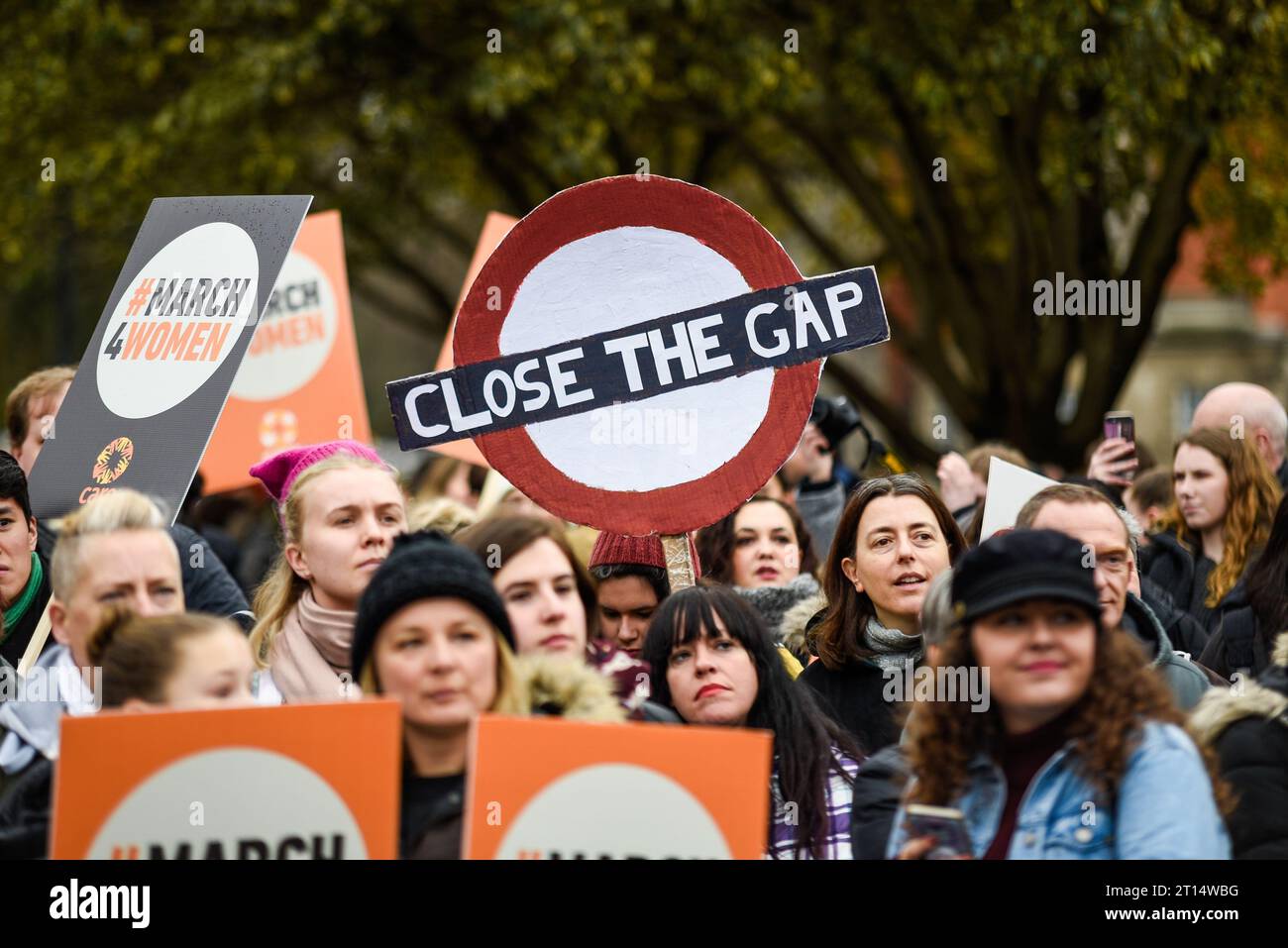 Close the Gap sign at the March 4 Women women's equality protest organised by Care International in London, UK. Gender pay gap placard Stock Photo