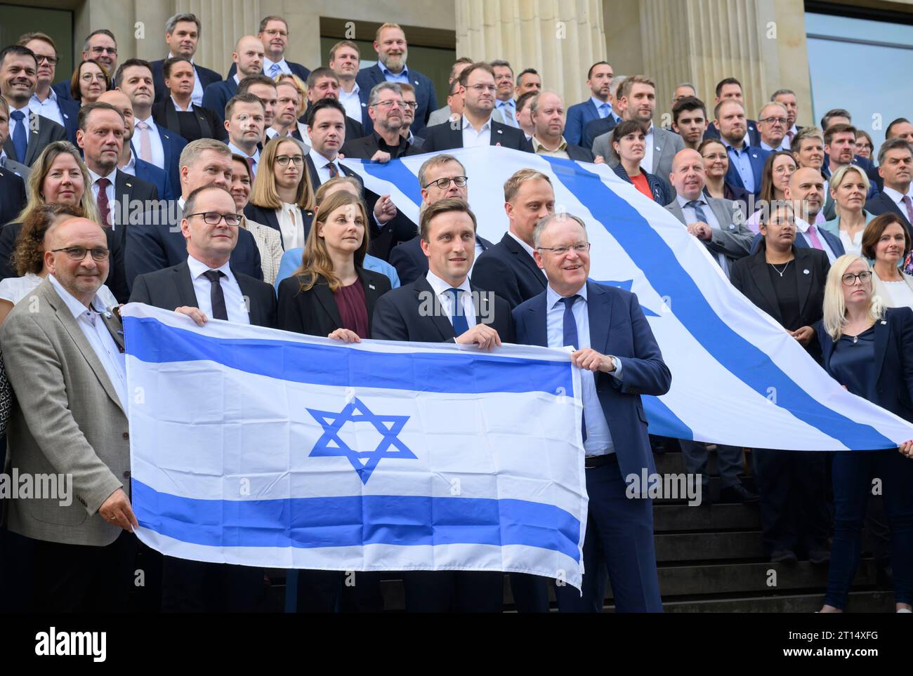 Hanover, Germany. 11th Oct, 2023. The parliamentary groups of SPD, Greens and CDU stand with Israel flags in front of the state parliament of Lower Saxony during a joint photo action. Representatives of all parties expressed solidarity with Israel in the state parliament. Credit: Julian Stratenschulte/dpa/Alamy Live News Stock Photo