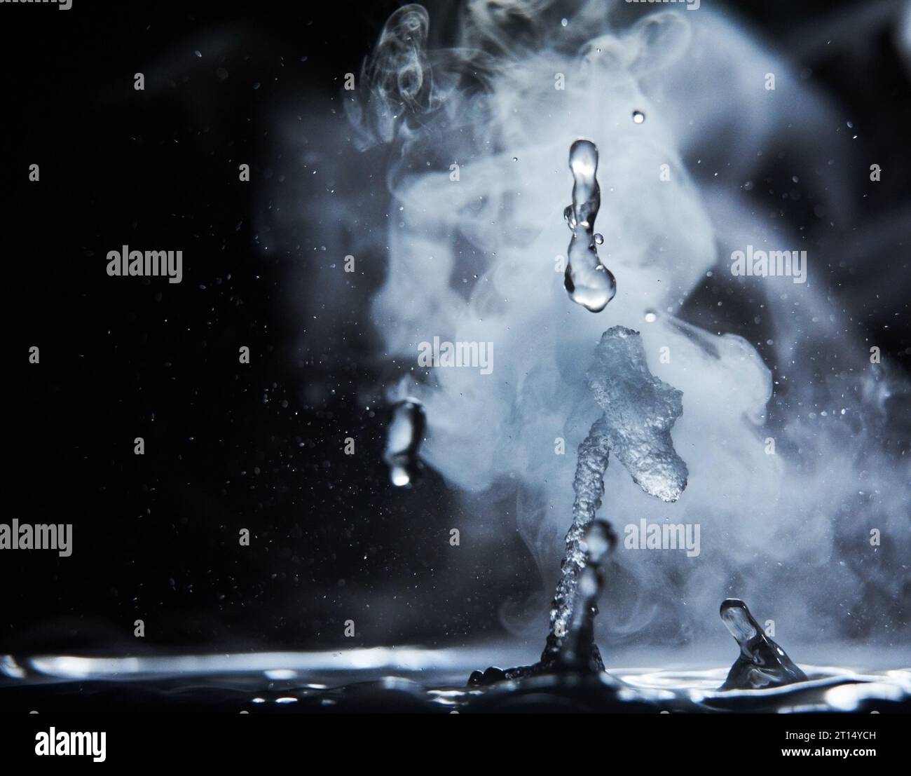 Boiling water splash with steam on black background closeup Stock Photo ...