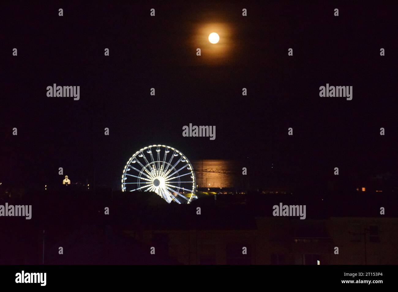 Carousel lit up at night & full moon, Antibes, Cote d'Azur, France Sep 2023 Stock Photo