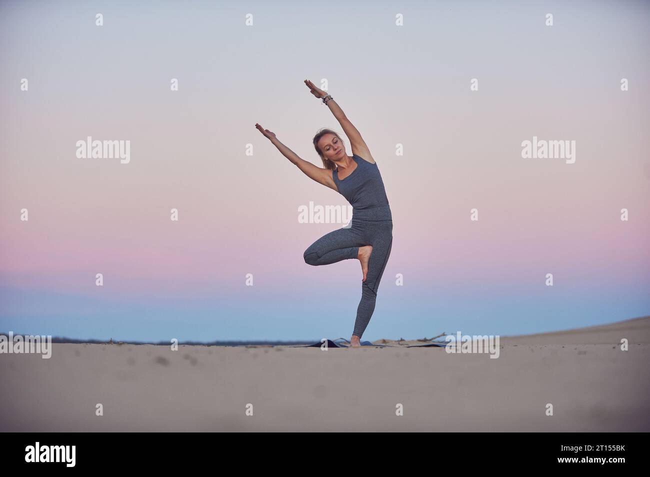 Beautiful young woman practices yoga asana Parshva Vrikshasana - Tree ...