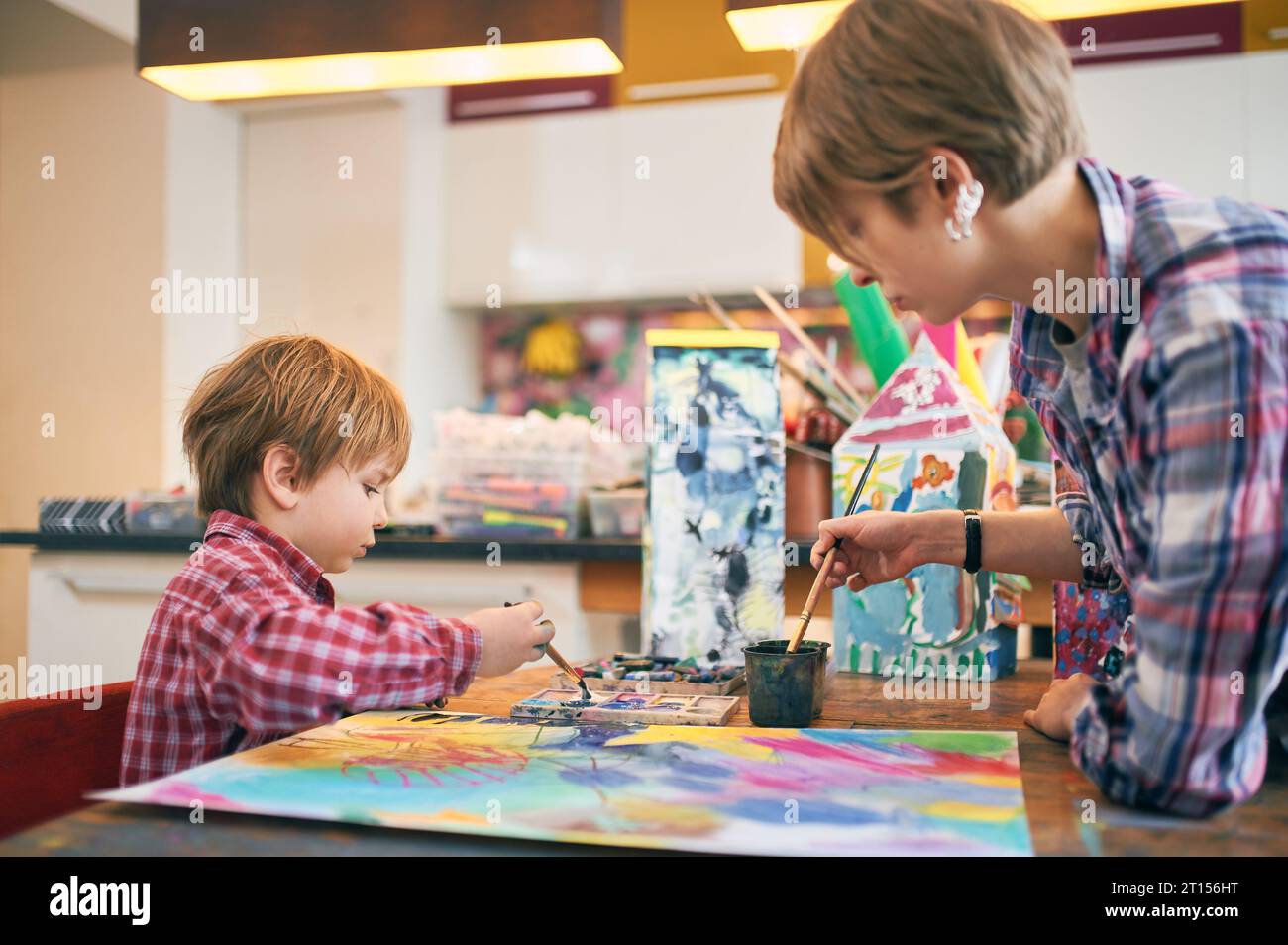 Cute happy little boy and teacher drawing in artist class. Education ...