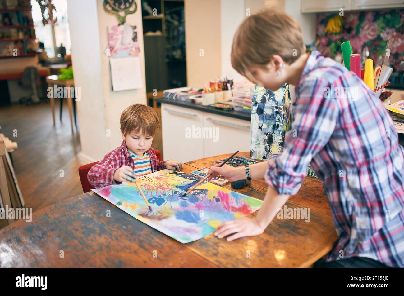Cute happy little boy and teacher drawing in artist class. Education ...