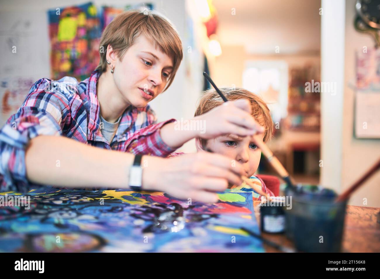 Cute happy little boy and teacher drawing in artist class. Education ...