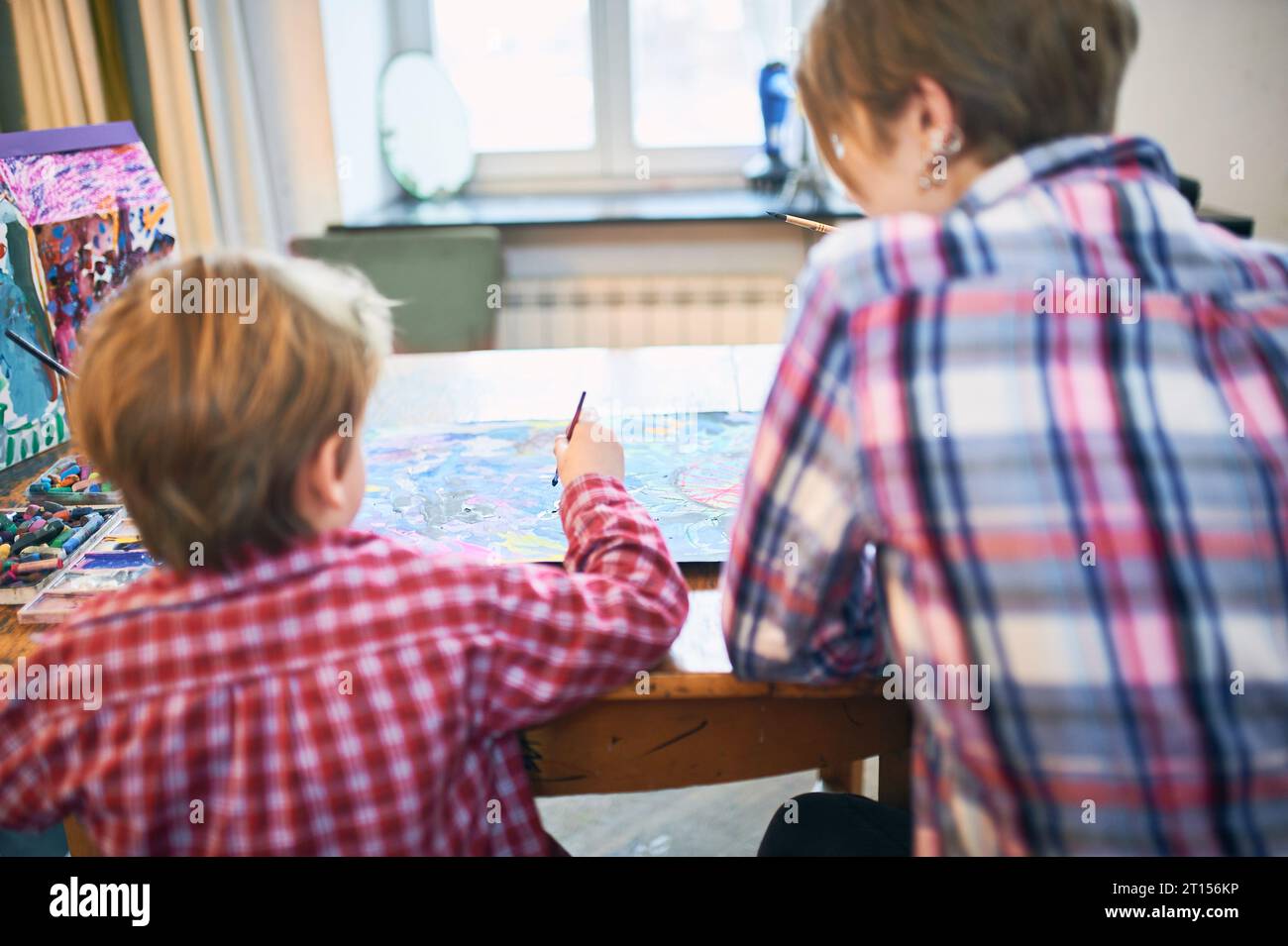 Cute happy little boy and teacher drawing in artist class. Education ...