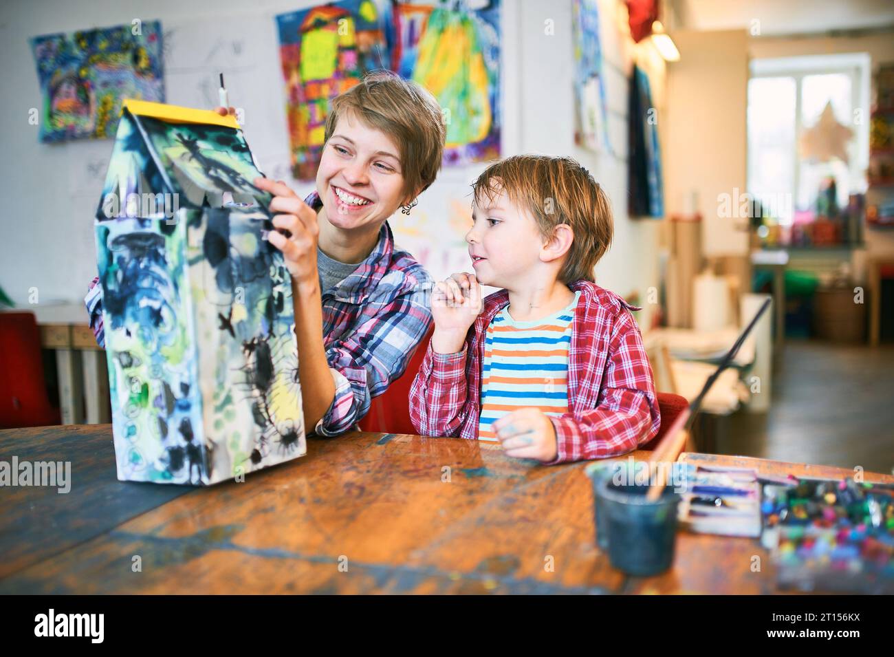 Cute happy little boy and teacher drawing in artist class. Education ...