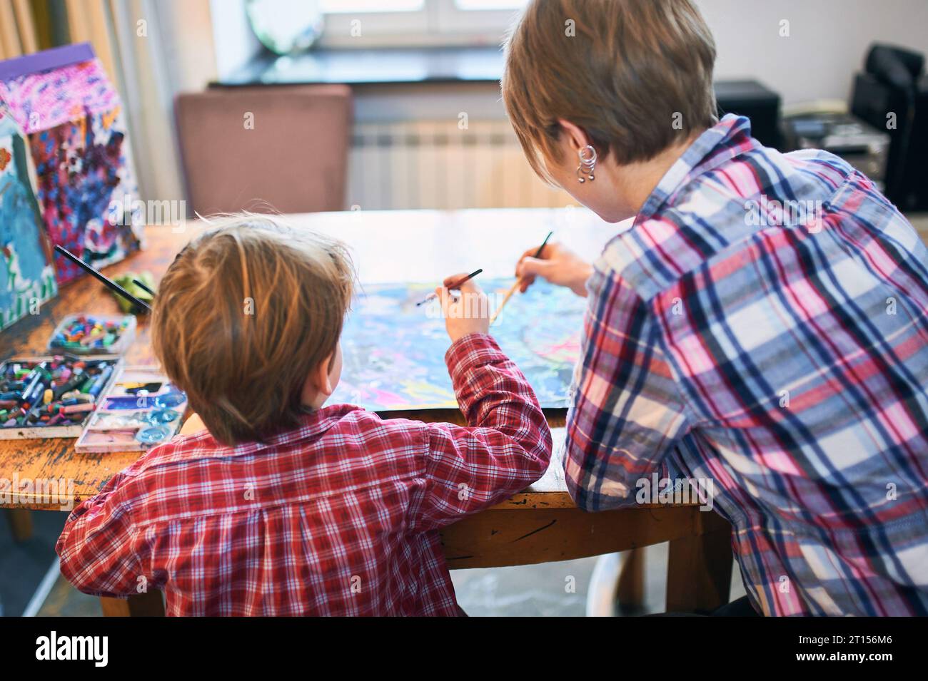 Cute happy little boy and teacher drawing in artist class. Education ...