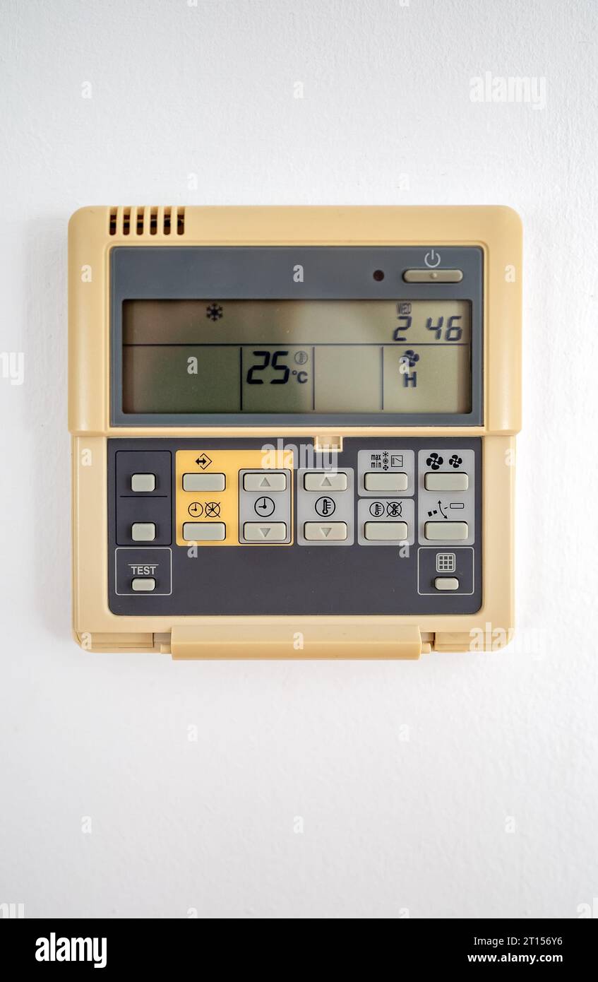 Close-up view of wall-mounted digital thermostat. Stock Photo