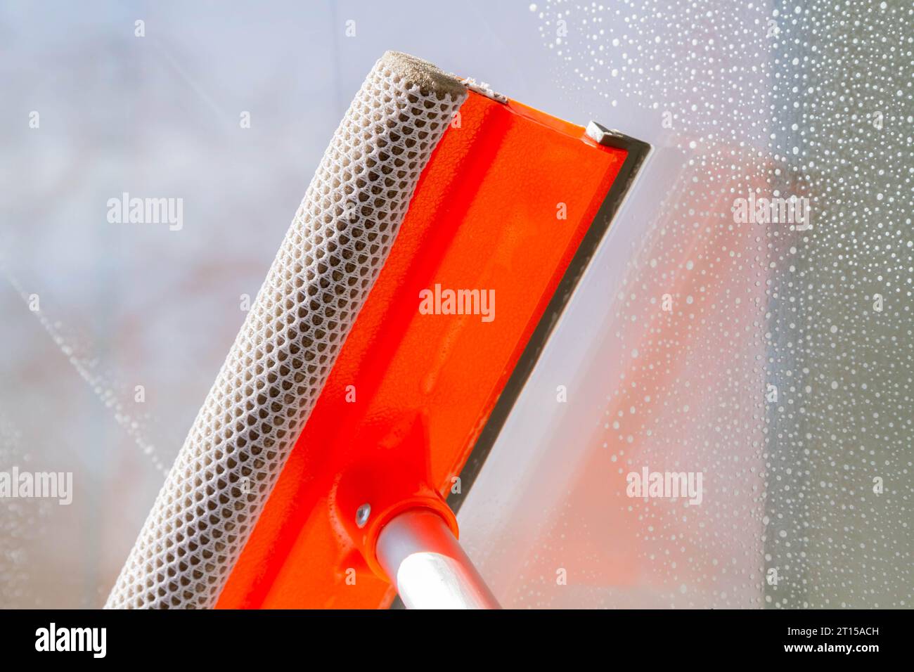 Window washing. Cleaning the window with a brush and foam. The concept