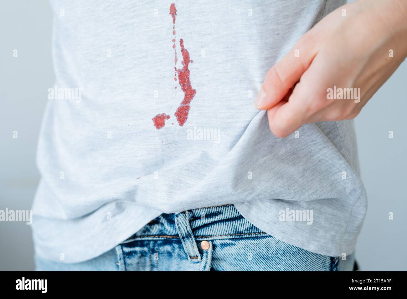 Drop stain of blood on a white tshirt. daily life stain concept Stock