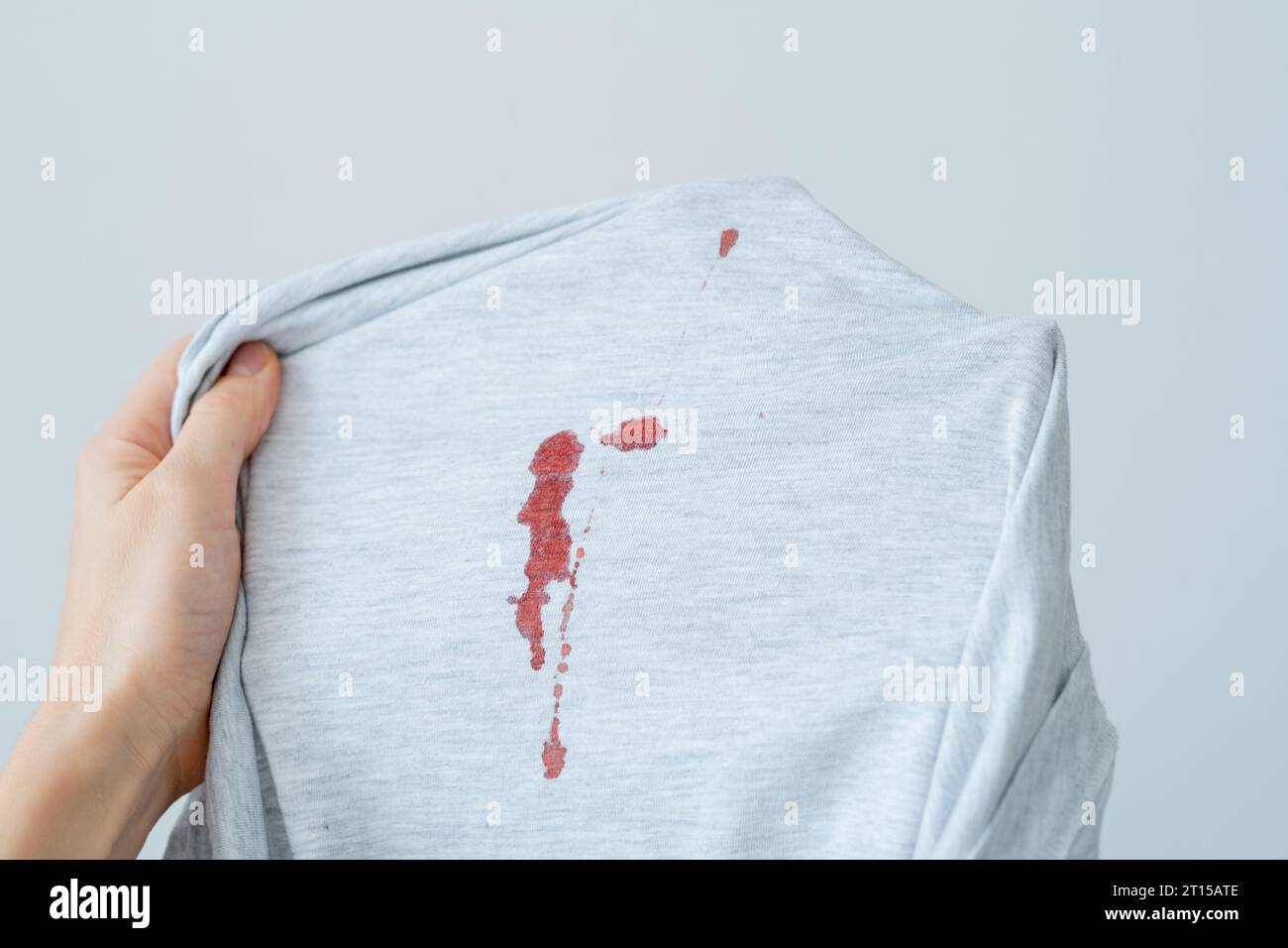 Drop stain of blood on a white t-shirt. daily life stain concept Stock Photo