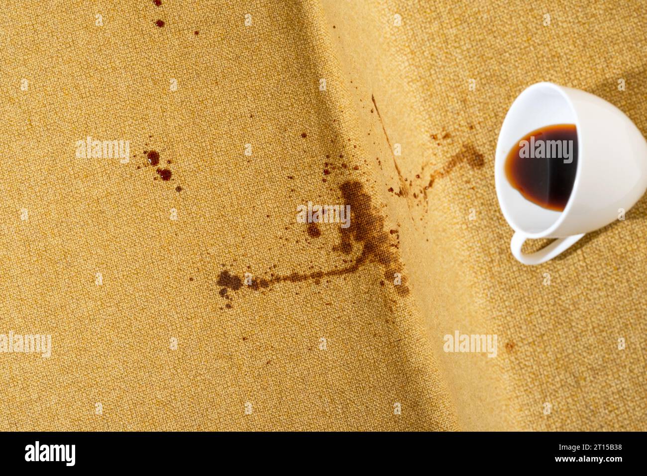 Accidental coffee spill on the sofa, creating a brown stain that marred