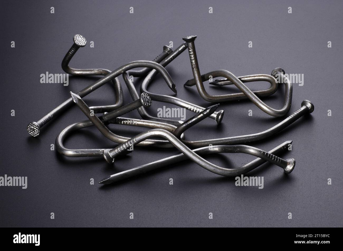Bent Construction Nails on gray plastic background Stock Photo - Alamy
