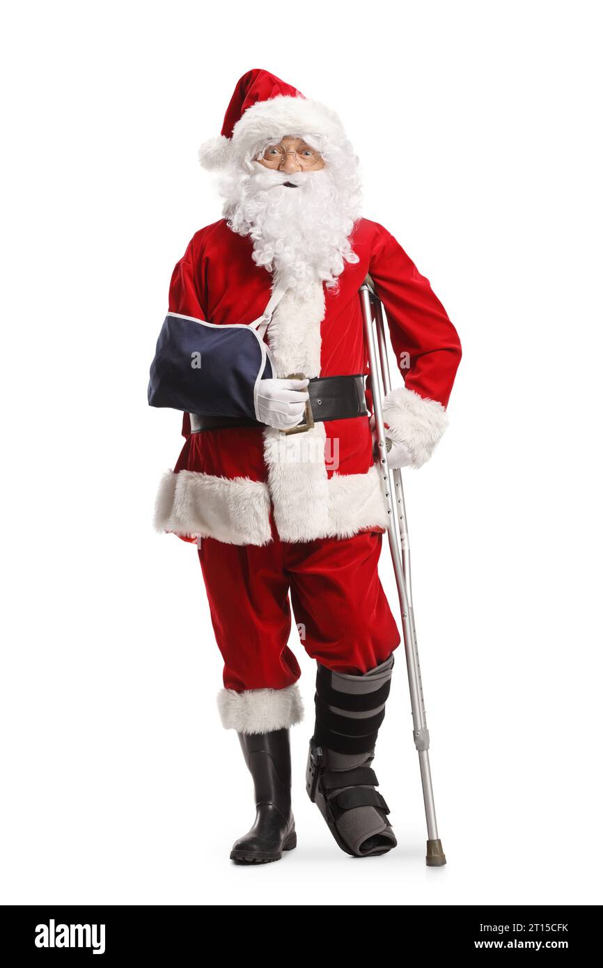 Santa claus with a foot brace and arm sling leaning on a crutch isolated on white background Stock Photo