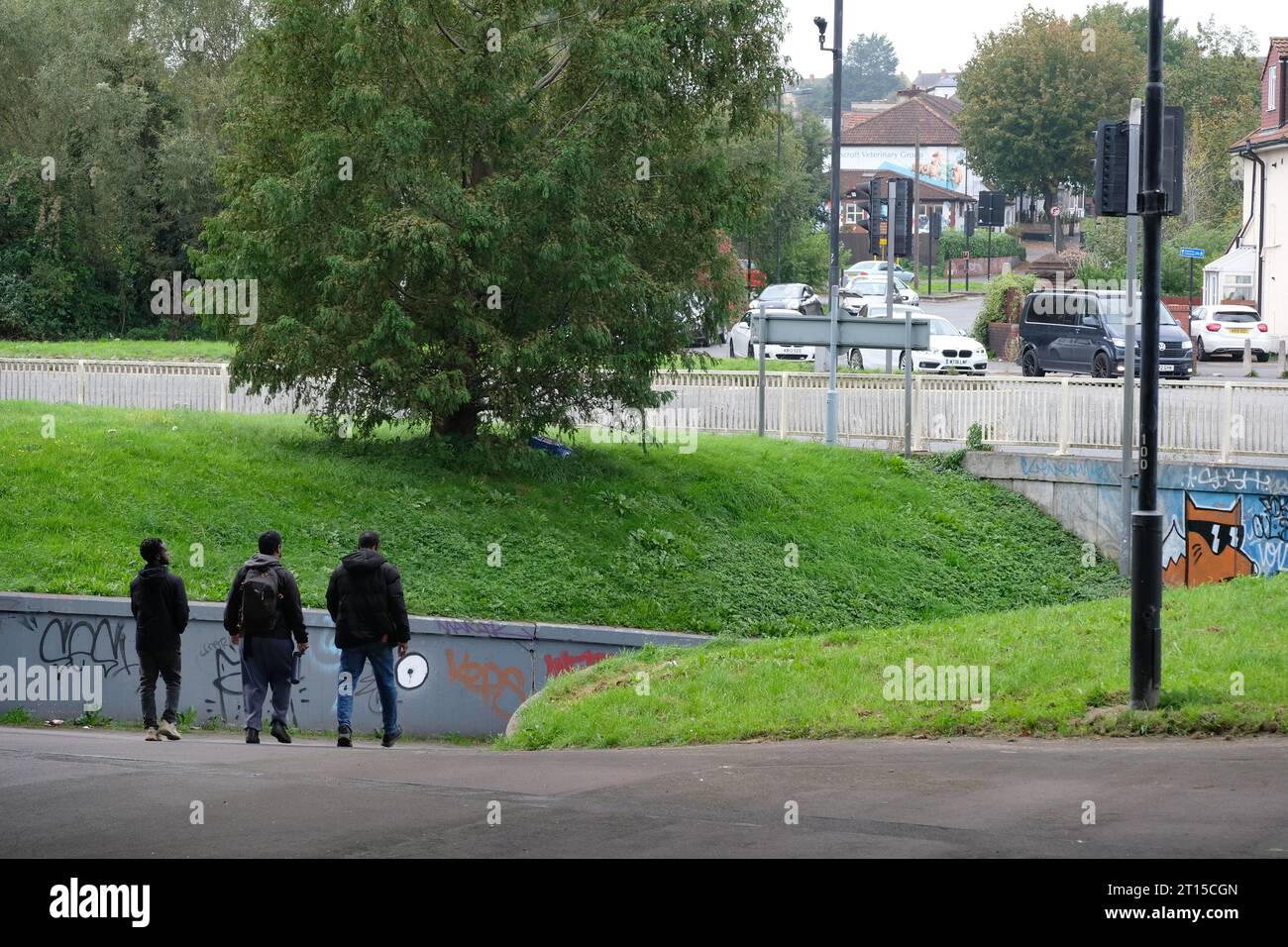Three men walking through the underpass of the M32 flyover in Eastville